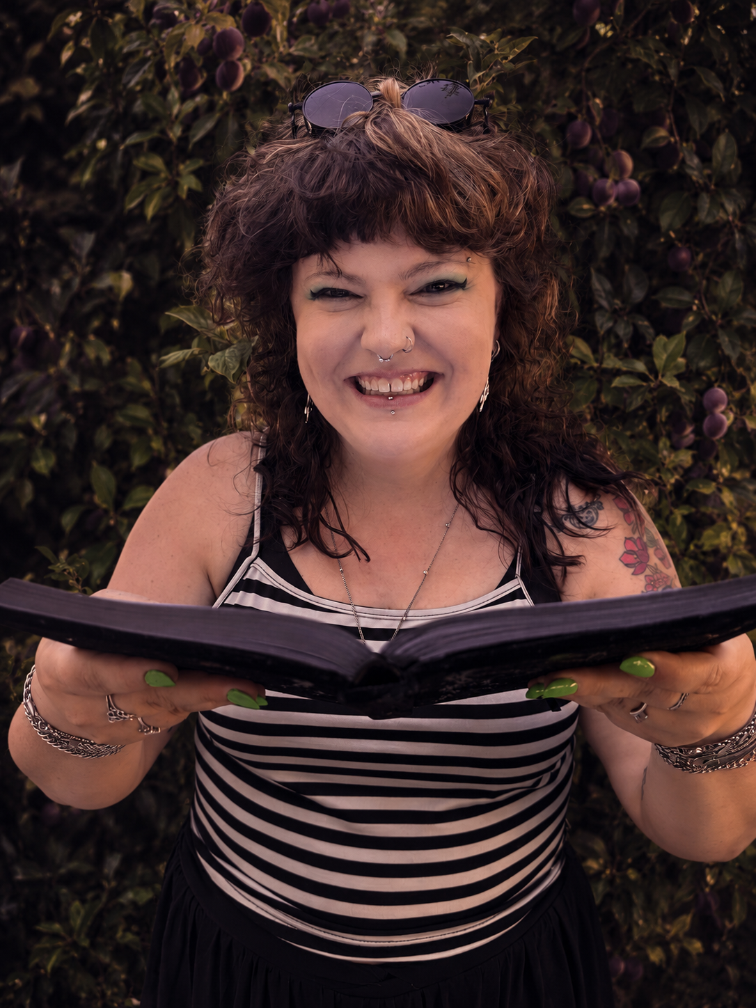 Morgan Rugg smiling while holding an open book